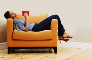 Woman in yellow chair with book